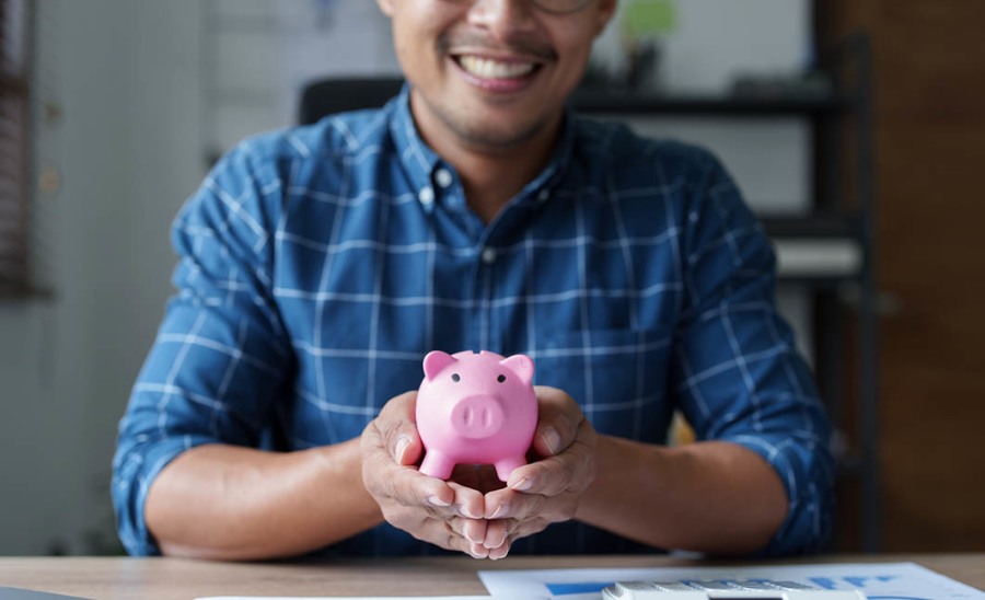 man with piggy bank in hands